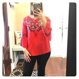 Red blouse with embroidered flowers